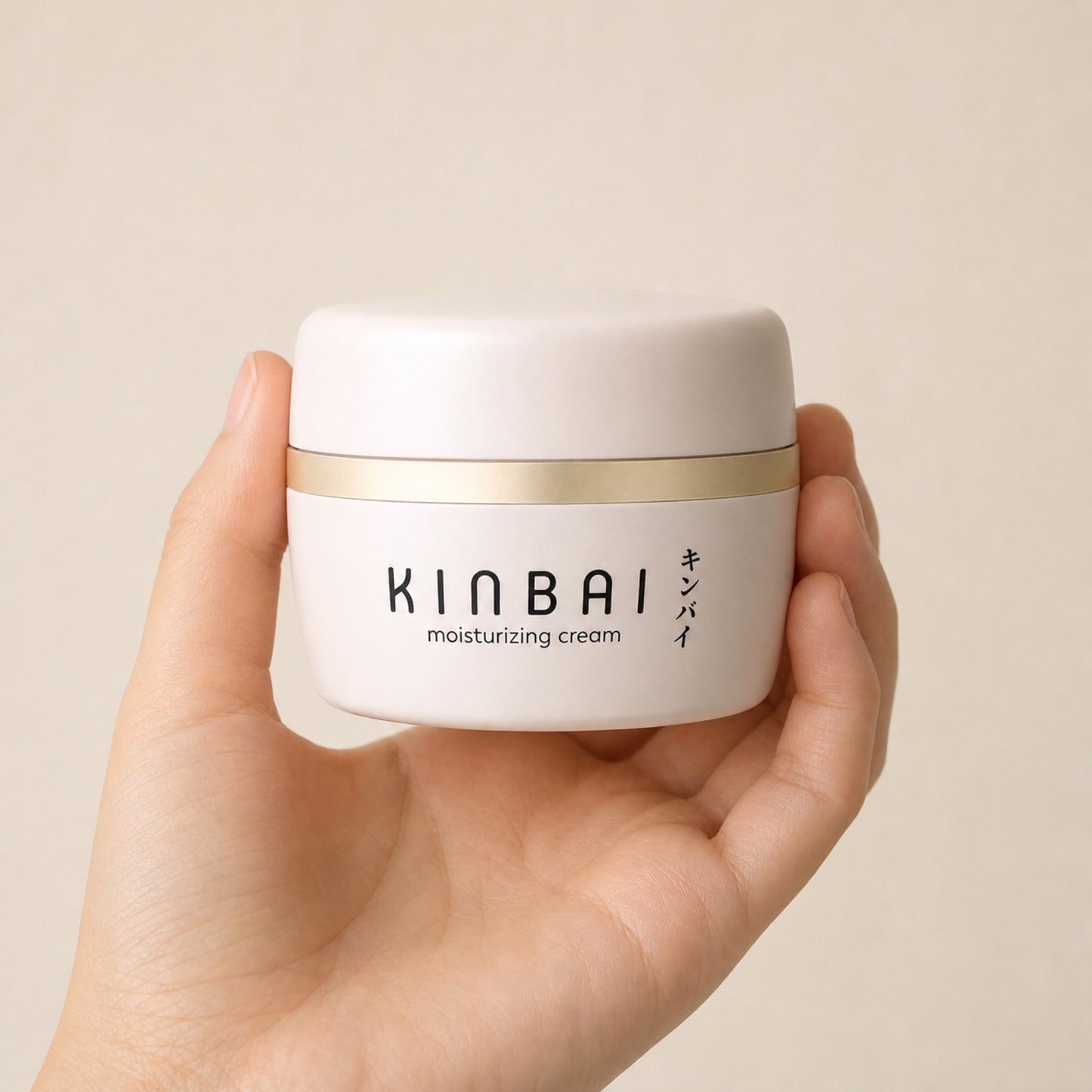 Kinbai Moisturizing Cream jar held in a hand, showing its size